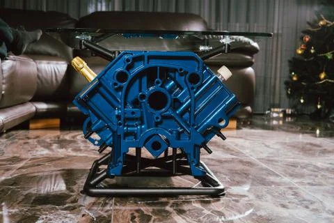 V8 Engine block table, painted in blue color. Loft stylish table furniture wi Stock Photos