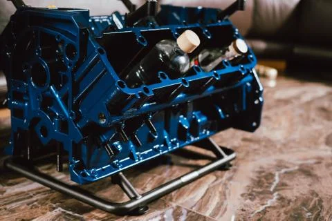 V8 Engine block table, painted in blue color. Loft stylish table furniture wi Stock Photos