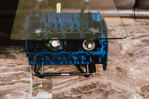 V8 Engine block table, painted in blue color. Loft stylish table furniture wi Stock Photos