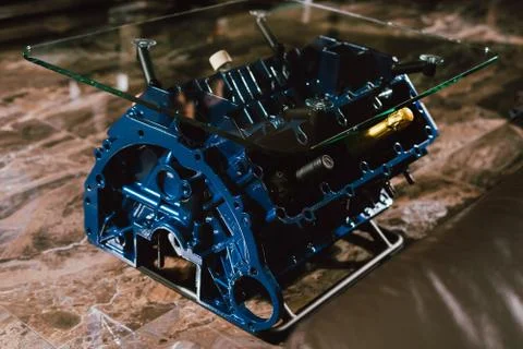 V8 Engine block table, painted in blue color. Loft stylish table furniture wi Stock Photos