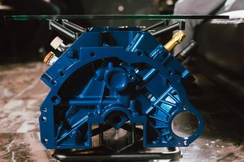 V8 Engine block table, painted in blue color. Loft stylish table furniture wi Stock Photos