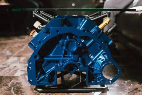 V8 Engine block table, painted in blue color. Loft stylish table furniture wi Stock Photos