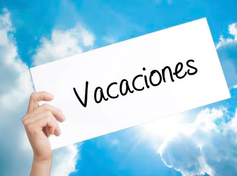 Vacaciones (Vacation In Spanish) Sign on white paper. Man Hand Holding Pape.. Stock Photos