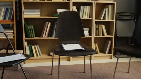 Vacant Chairs with Test Sheets Arranged in Circle in Group Therapy Room Видео 326670235