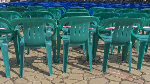 Vacant empty plastic chairs pattern. A lot of chairs for spectators. Comforta Stock Photos