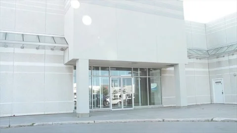 Vacant generic empty store storefront beige white clean with no sign or logo Stock Footage 249757635