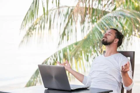 Vacation and technology. Work and travel. Young bearded man using laptop Stock-Fotos
