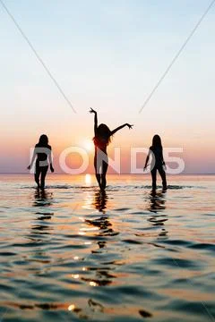 Vacation. Beach Party. Teenage girls having fun in water. Group of happy young Stock Photos