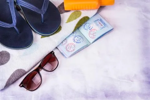 Vacation concept. Summer beach background with sunglasses, slippers, passport Stock Photos