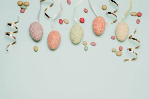 Vacation holiday concept with multicolored easter eggs, dragee candies and gold Stock Photos