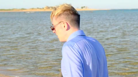 Vacation or rest on the sea. Side view of attractive male businessman Stock-Footage 201736077