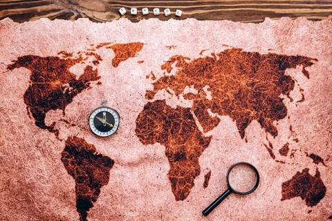 Vacation planning concept. On the map of the world is a magnifying glass, a.. Stock Photos