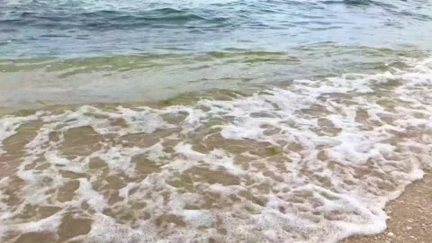 Vacation. relaxation. sea waves flow to the sandy shore. close up view Stock Footage 156511611