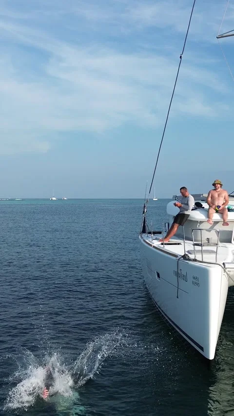 Vacation at sea. A guy doing a backflip from a yacht. Vacation fun on a yacht. Stock Footage 315881887