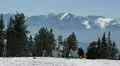 Vacation Ski Resort Young Skiers Resting Enjoy Panoramic Mountain Winter Scene HD Footage