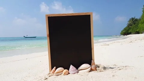 Vacation theme wallpaper with an empty blackboard plunged on white sand Stock Footage 118594198