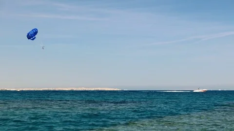 Vacation, tourism at seashore resort of Egypt. Parasailing over the Red Sea Stock Footage