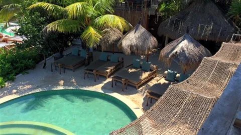 Vacation. Tropical resort showcases inviting sun loungers 動画素材 339645533