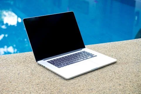 Vacation work with laptop at pool Stock Photos