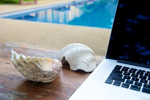 Vacation work with laptop at pool Stock Photos