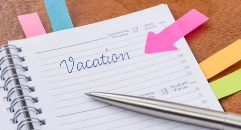 Vacation written on a page in a planner 스톡 사진