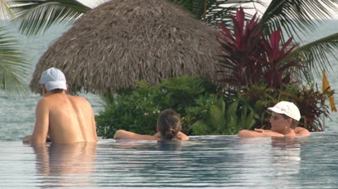 Vacationers relaxing in an infinity pool. Video stock 28796719