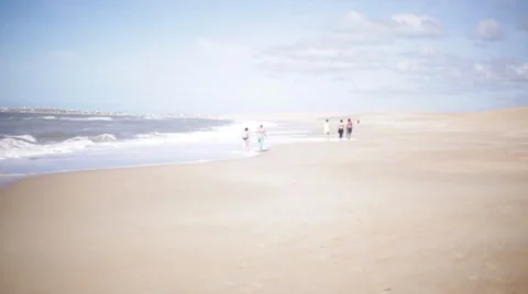 Vacationers strolling on beach Stock Footage 63292081