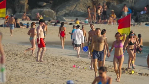 Vacationing tourists on the beach Stock Footage 278820971