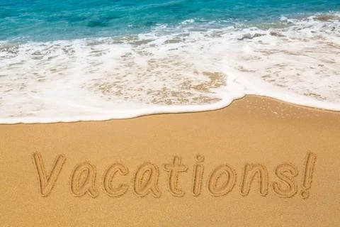 Vacations written in sand with sea surf Vacations words written into sand ... Stock-Fotos