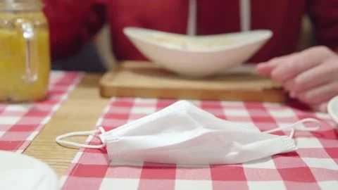 Vaccinated man eats a lunch with vitamin tea at a restaurant during the Stock Footage 163378943
