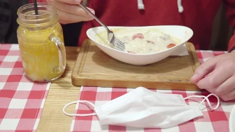 Vaccinated man eats turkey julienne at a restaurant during the pandemic. Anti Stock Footage 163174025