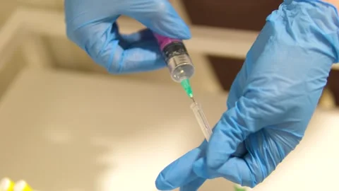 Vaccination Clear liquid drips from needle of a syringe Vaccine syringe slow Stock Footage 282078067