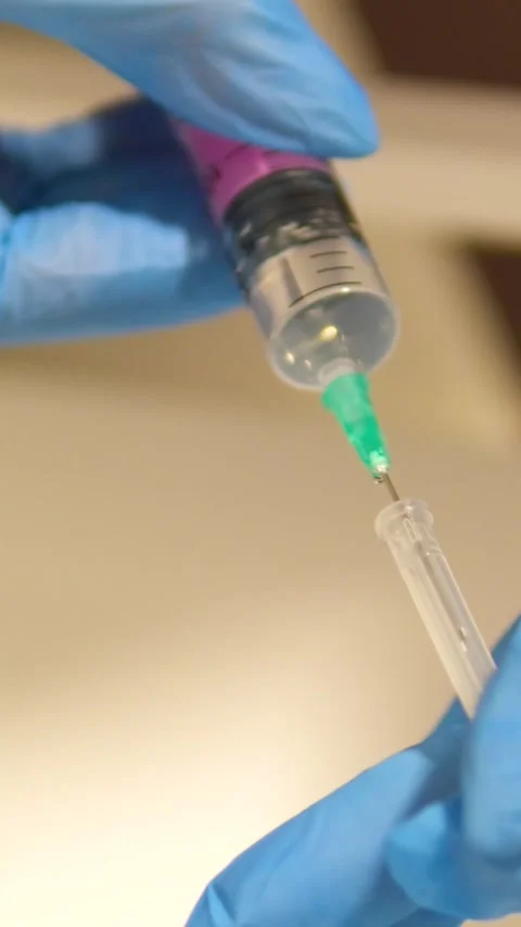 Vaccination Clear liquid drips from needle of a syringe Vaccine syringe slow Stock Footage 282078422