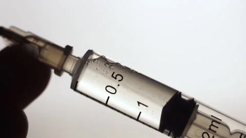 Vaccination concept, drawing clear liquid into a syringe close up. bubbles Video stock 155701589
