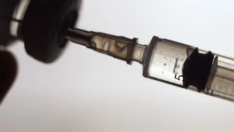 Vaccination concept, drawing clear liquid into a syringe close up. bubbles Video stock 202094131