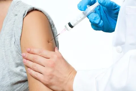 Vaccination. Doctor injecting flu vaccine to patient's arm.  Doctor making wo Stock Photos