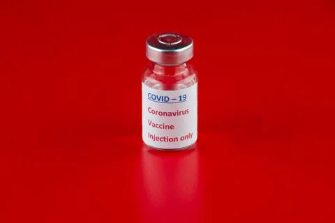 Vaccine for COVID - 19 Coronavirus on red background Stock Photos
