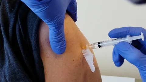 Vaccine needle in the arm Stock Footage 125548567