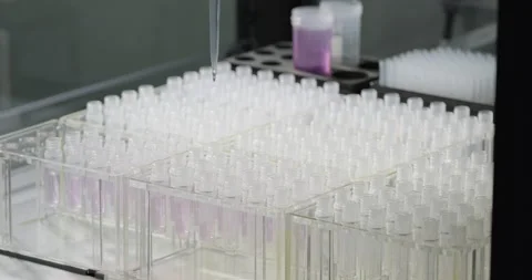 Vaccines and medicines development. Robotic arm pours liquid into test tubes Stock Footage 265249620