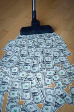Vacuum cleaner and dollar notes Stock Photos