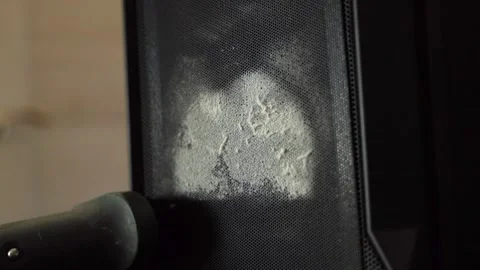 Vacuum cleaner brush removing dust from speaker grill Stock Footage 313673592