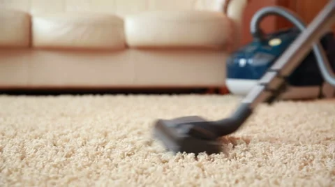 Vacuum cleaner cleaning the carpet, dolly shot Stock Footage