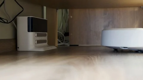 Vacuum Cleaner Robot is put on charge Stock Footage 124310347