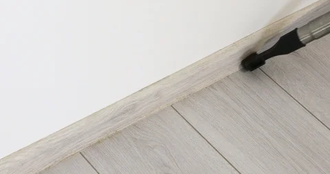 Vacuum cleaner rolling from side to side on a parquet floor Stock Footage 103353981