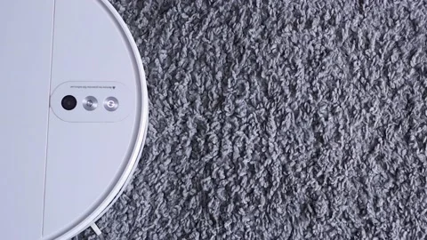 The vacuum cleaner starts moving. 스톡 동영상 217398086