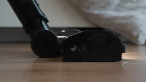 An vacuum cleaner suctioning a large amount of fallen hair on the floor at home. Stock Footage 327847148