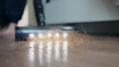 An vacuum cleaner suctioning a large amount of fallen hair on the floor at home. Stock-Footage 327847173