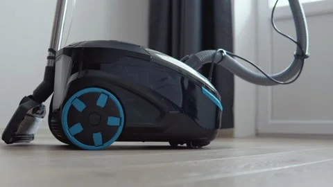 A vacuum cleaner with a wet cleaning function is in the room. Black with blue Video stock 154060305