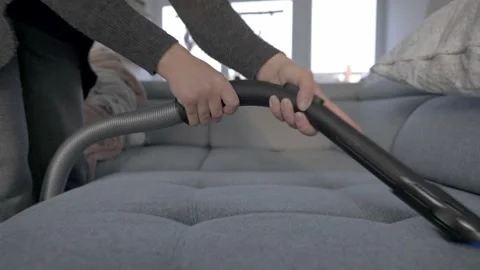 Vacuum-cleaning the couch Stock Footage 152848383