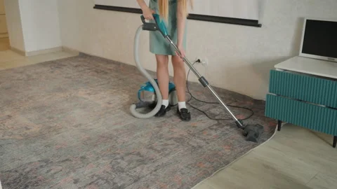 Vacuum operator uses wand on soiled carpet. Professional cleaner meticulously Stock Footage 336863839